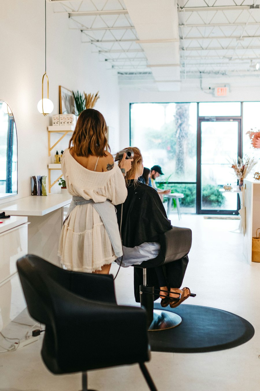 A woman getting her hair styled