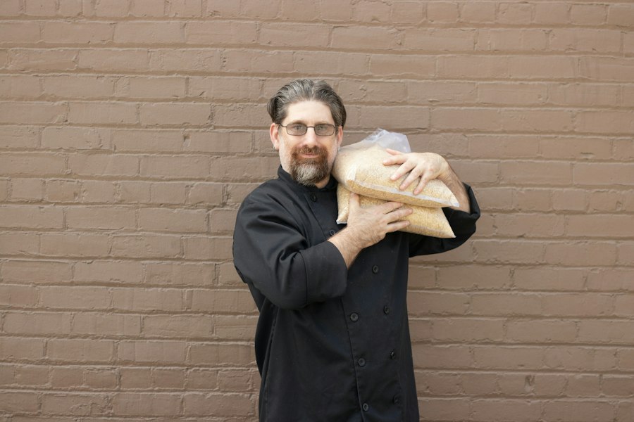 A baker holding fresh loaves
